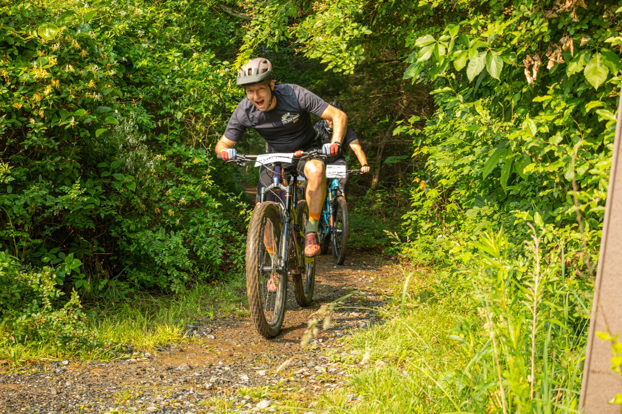 Massanutten mountain biking western slope group of mountain bikers on meadow trail 03