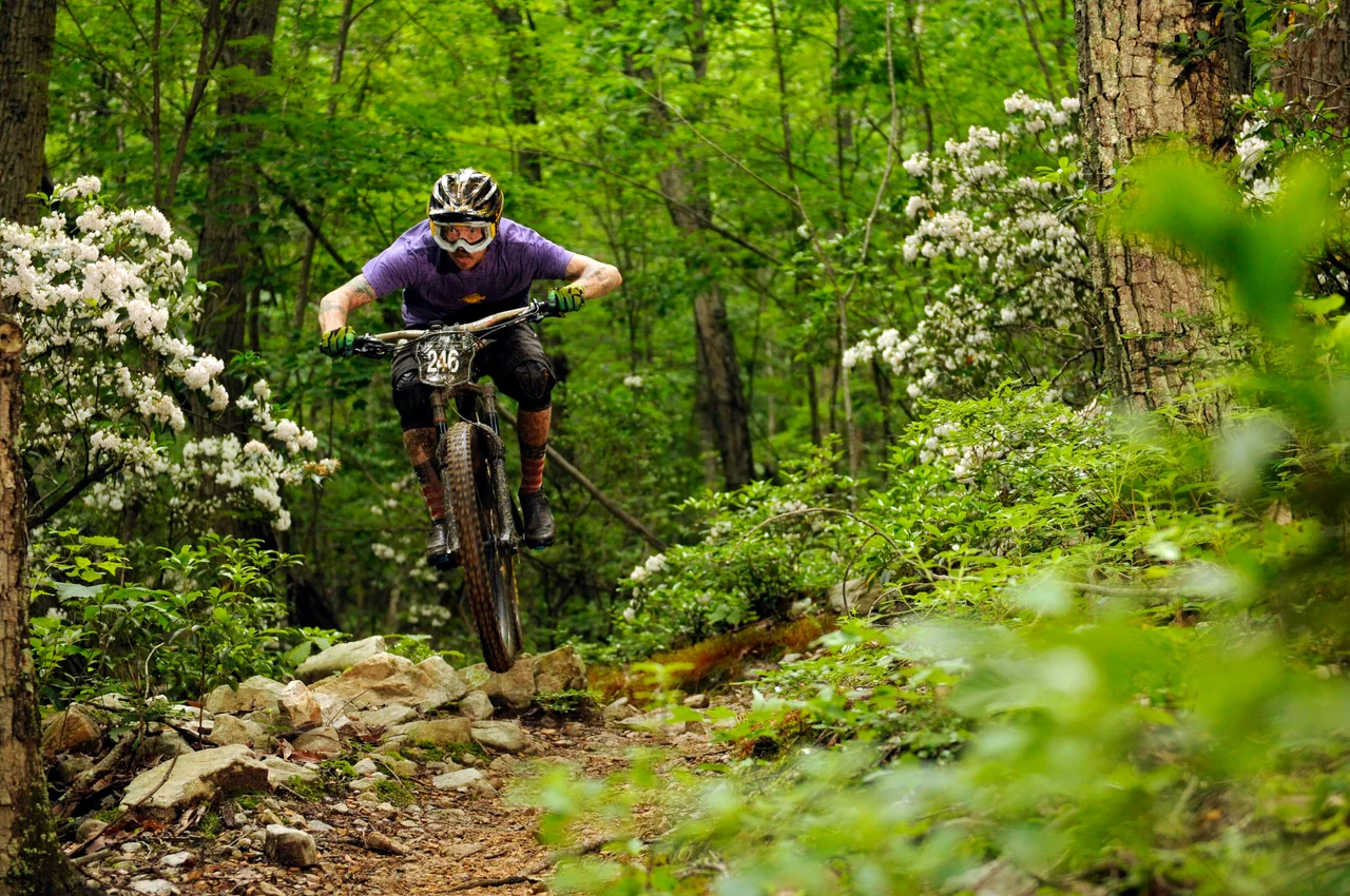 Massanutten mountain biking western slope mountain biker on grassy mountain trail 16